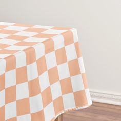 an orange and white checkered table cloth