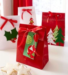 three small bags with christmas decorations on them