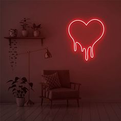 a heart shaped neon sign hanging from the side of a wall next to a chair