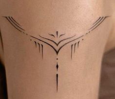 a woman's leg with a bird tattoo on the side of her leg and an arrow