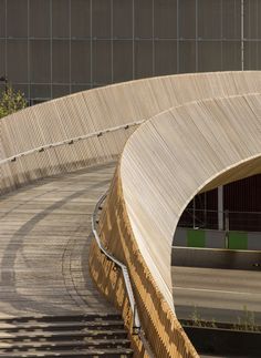 an overhead view of a curved wooden bridge