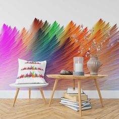 a room with a table and two chairs in front of a colorful wall