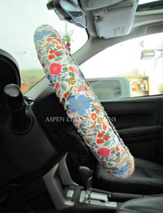 the inside of a car with a flower print umbrella