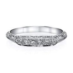 a white gold wedding band with five diamonds on the top and bottom, set in 18k