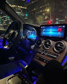 the interior of a car with blue lights