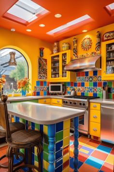 a colorful kitchen with an island counter and stools in front of the stove top