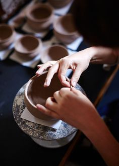 two people reaching for something in a bowl