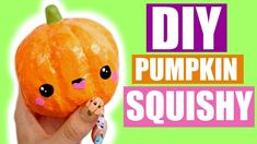 someone is holding up a pumpkin with the words diy pumpkin squishy on it