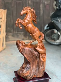 a wooden statue of a horse standing on its hind legs