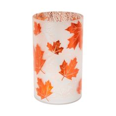 an orange and white glass vase with leaves on the inside, sitting in front of a white background