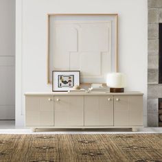 a living room with a large rug and white walls