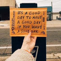 someone holding up a sign that says it's a good day to have a good day if you want a good day