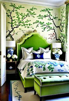 a bedroom decorated in green and white with trees painted on the wall