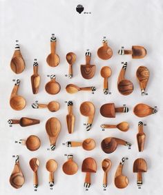 wooden spoons and measuring spoons are arranged in rows