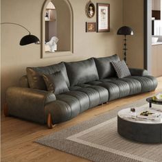 a living room filled with lots of furniture and decor on top of a hard wood floor