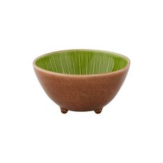 a brown and green bowl sitting on top of a table