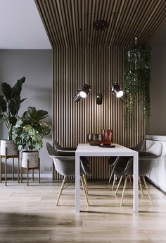 a dining room table with chairs and plants on the wall next to it in front of a wooden paneled wall