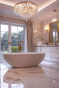 a bathroom with a large bathtub and chandelier in the middle of it