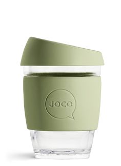 a glass cup with a green lid and the word joco on it's side