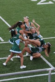 a group of girls in cheerleaders on a field