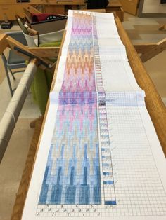 a table that has some paper on top of it, and a ruler in front of it