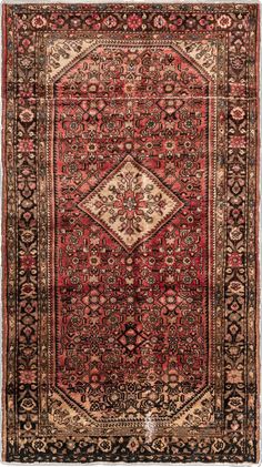 an antique rug with red and black colors