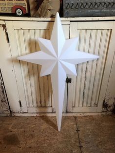 a white paper star on top of a wooden table