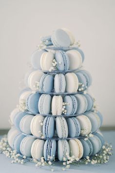 a stack of blue and white macaroons sitting on top of eachother