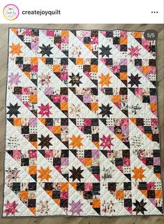 an orange and black quilt on a wooden floor with text overlay that reads, createjoyquilit