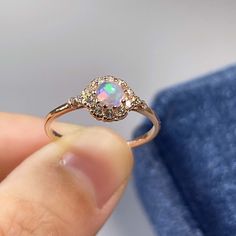 BASIC OPAL INFORMATION Round Opal : 5*5mm. Main stone: Natural good fire opal. Side stone: dainty cz diamond (cubic zircon). Material: 925 Sterling Silver +Natural opal stone. Metal color: silver, gold, rose gold. Metal materials: 925 sterling silver, 18K rose gold Plated, 18K rose gold Plated. SIMPLE DESIGN AND GOOD FIRE Delicate opal ring, that is perfect for stacking or wearing alone. A true beauty and must have! Sweet, simple, and dainty ring. Perfect for a minimalist look. They range from a Rose Gold Pink Opal Round Jewelry, Rose Gold Pink Opal Jewelry, Elegant Pink Opal Moonstone Ring, Ethiopian Opal Ring For Wedding, Gold Opal Ring With Accent Stones, Rose Gold Pink Opal Jewelry For Wedding, Opal Gemstone Crystal Ring For Anniversary, Adjustable Round Opal Ring With Stone Setting, Opal Ring With Cubic Zirconia And Halo Setting