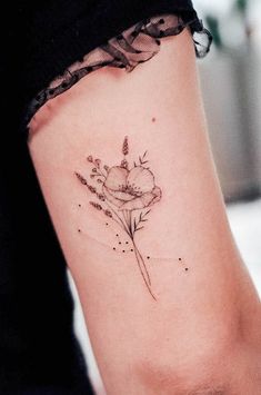 a woman's arm with a flower tattoo on the left side of her body