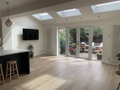 an open kitchen and living room with sliding glass doors