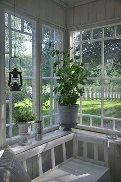 a window seat with potted plants on the windowsill