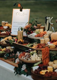 an assortment of cheeses and crackers on a table with a sign that says celebration