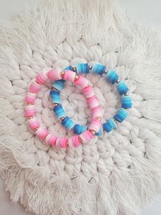 two bracelets on top of a white blanket