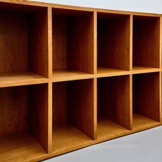 a wooden shelf with six compartments on each side