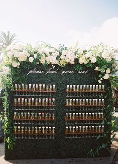 an outdoor display with flowers and wine bottles