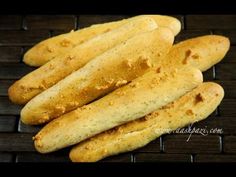 some bread sticks are sitting on a cooling rack, ready to be cooked in the oven