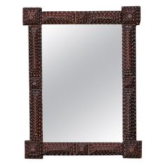 a mirror that is sitting on top of a wooden frame with an intricate design in the middle