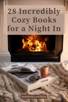 a book and cup on a blanket with the words 28 incredibly cozy books for a night in