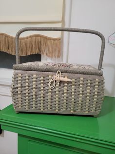 a wicker basket sitting on top of a green table