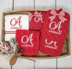 three personalized towels in a tray with pine cones