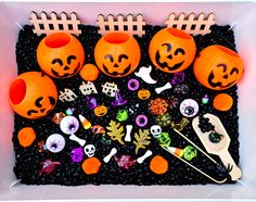 an assortment of halloween decorations in a plastic container