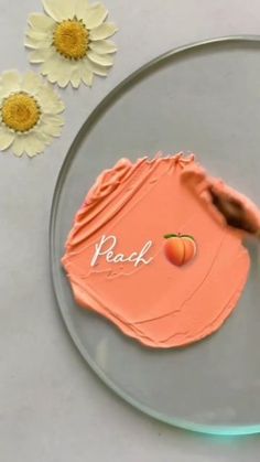 a piece of cake that has been decorated with peaches and the word peach on it