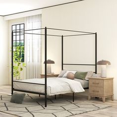 a bedroom with a four poster bed and white walls