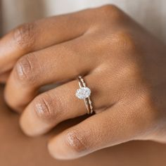 a woman's hand with a diamond ring on it