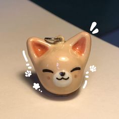 a cat shaped keychain sitting on top of a table