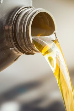 oil pouring from a bottle into a container