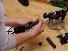 a person is working on some kind of device that they are holding in their hands