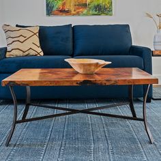 a living room with a blue couch and coffee table